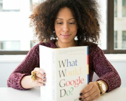 γυναίκα διάβαζει βιβλίο με τίτλο what would google do