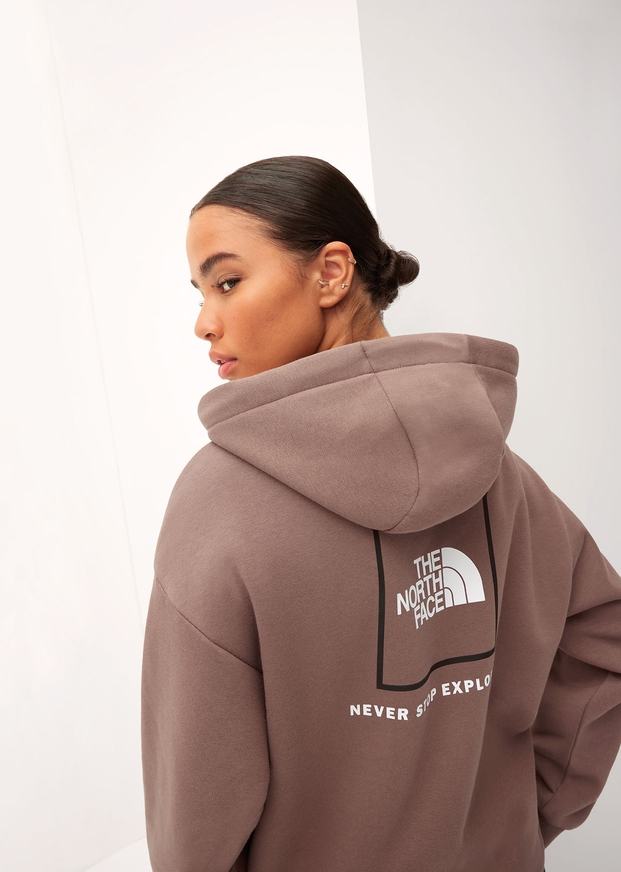 Young woman wearing a brown North Face hoodie